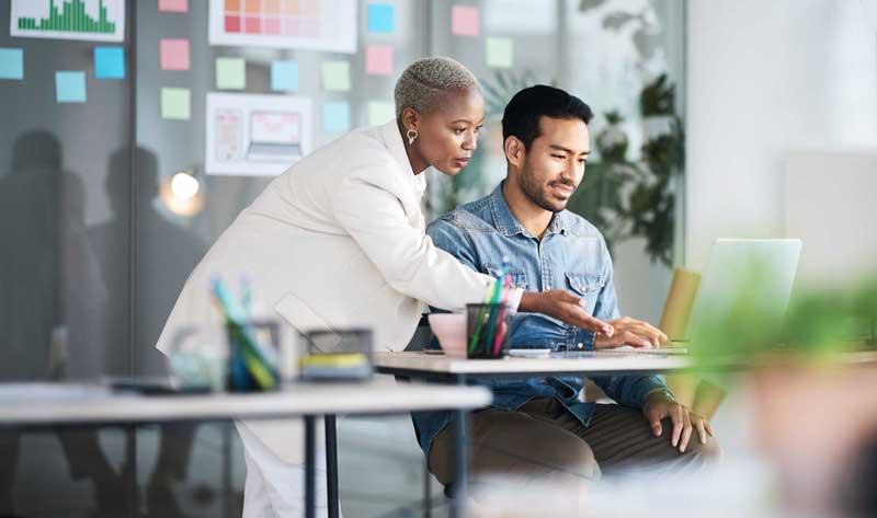 Two colleagues looking at a screen