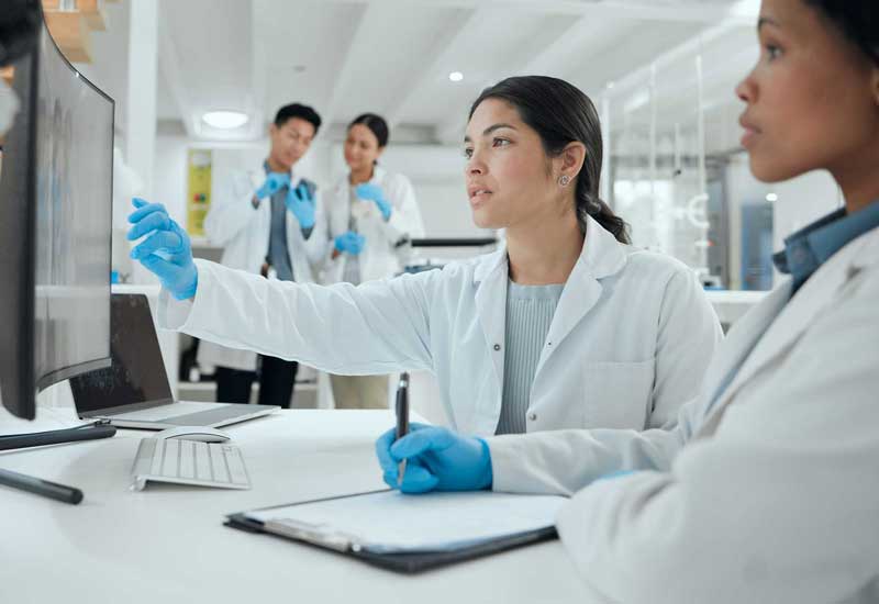 Scientists looking at a computer screen