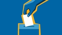 Hand putting a ballot in a box